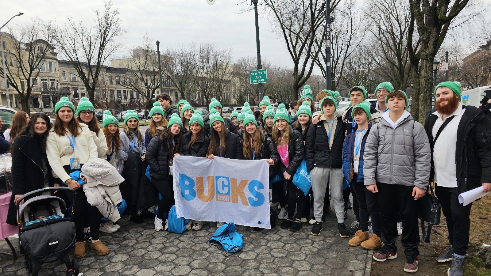 CTeen Bucks teens holding their banner for a group photo on a CTeen trip