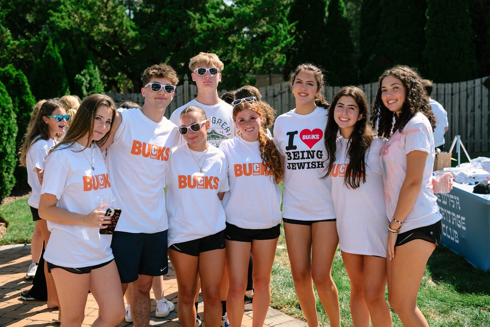 Teens around the food tables at the CTeen Bucks kickoff BBQ