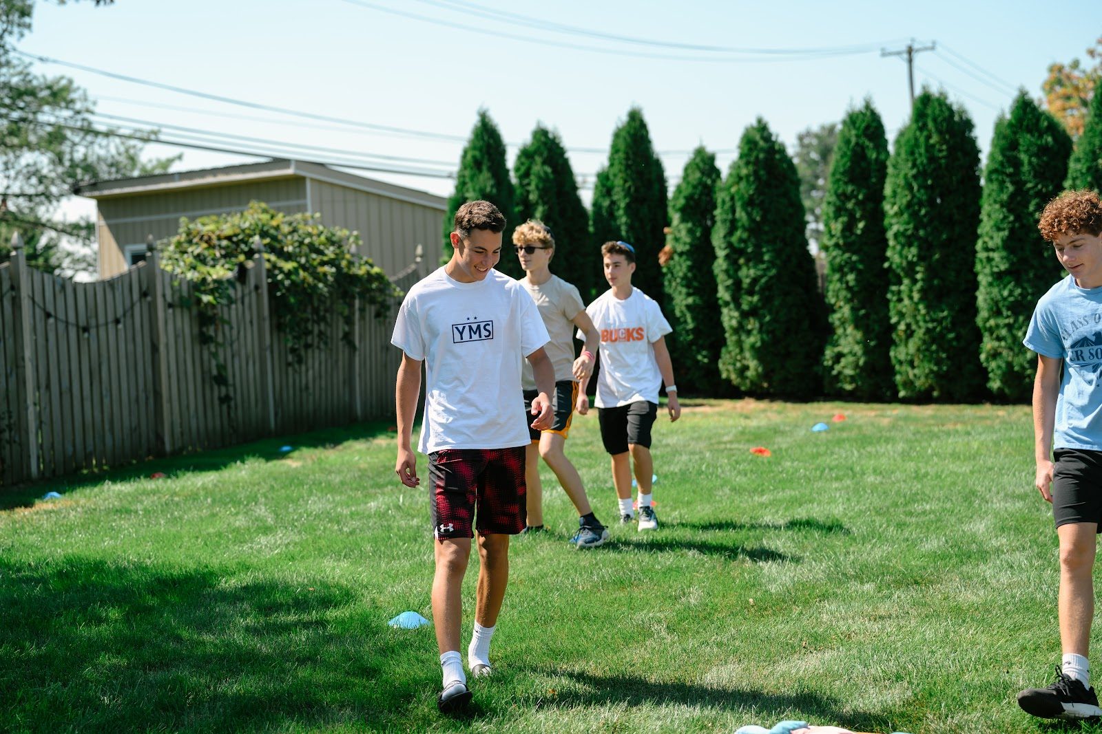 Teens hanging out on the grass together at a CTeen Bucks event
